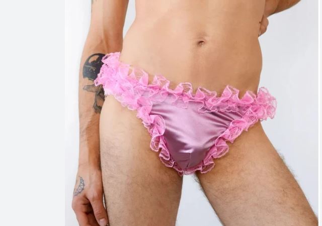 tiny pink chastity cage tied with satin ribbon