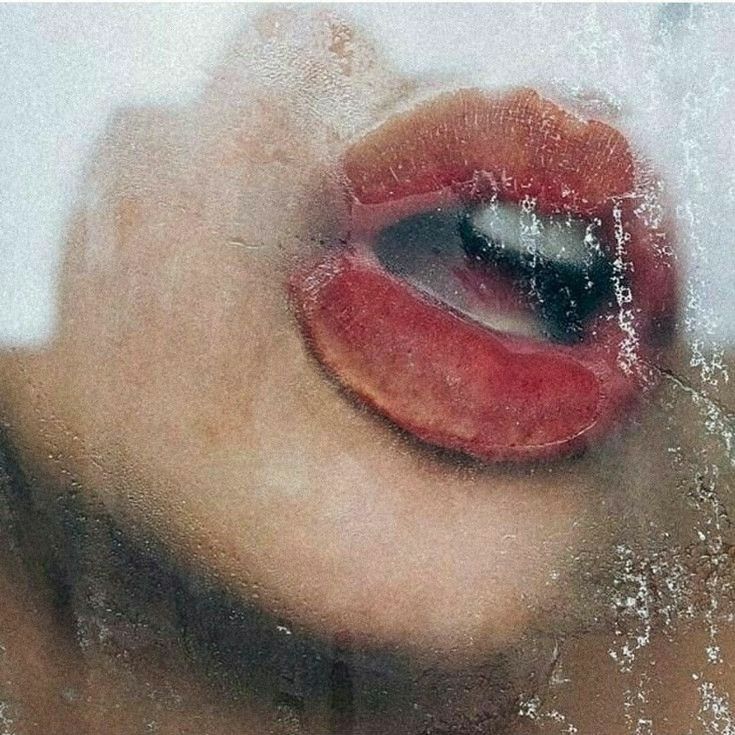 Close up of soft parted lips in fogged mirror light