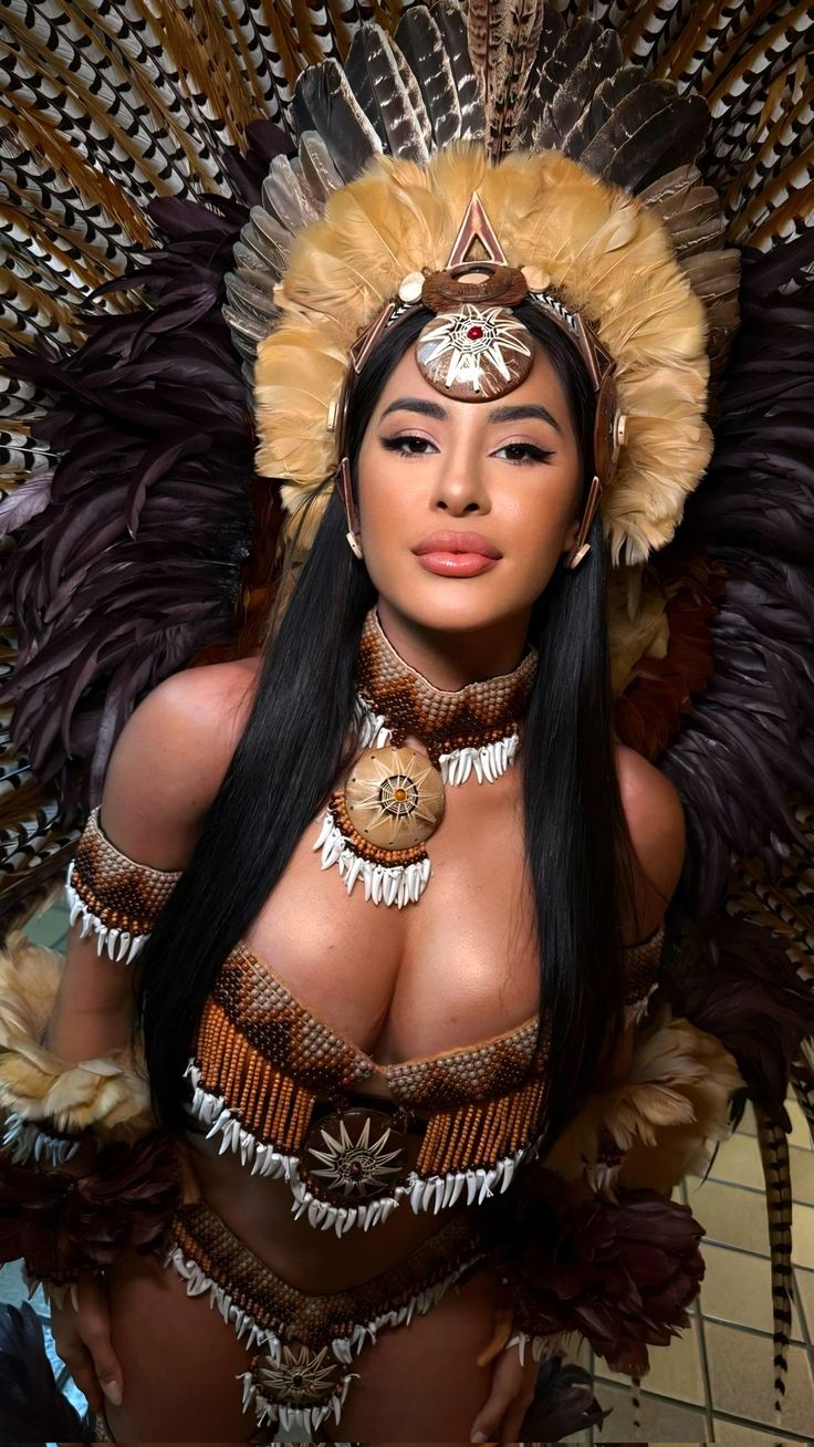 Jazmine in elaborate tribal feather headdress and beaded costume